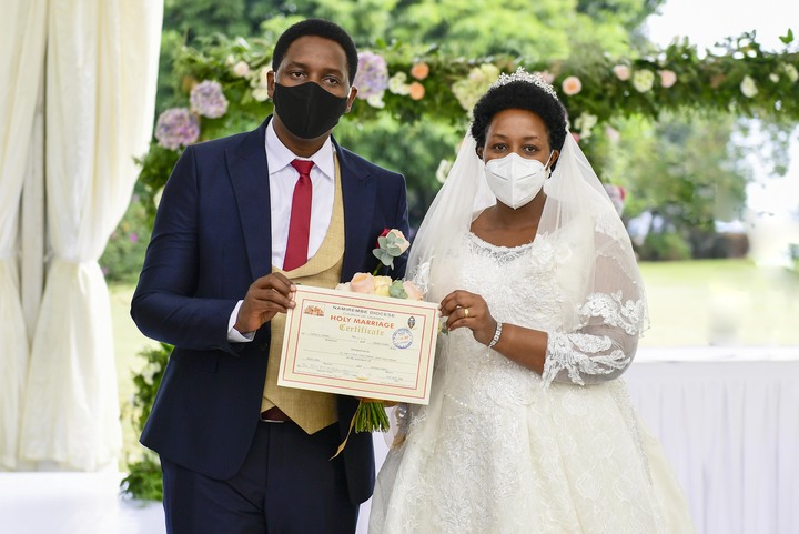 We did it: The couple displays a marriage certificate