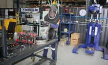 A Komatsu worker grinding a DPF.