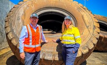 Fairweather and King in front of an OTR tyre destined for recycling. Credit: Alcoa