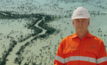Beach Energy CEO Brett Woods stands in front as Queensland floodwaters surge down Cooper Creek, isolating Innamincka and threatening nearby uranium and gas operations