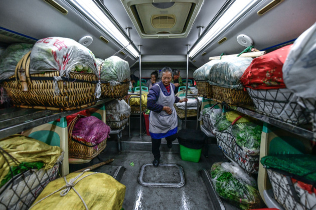 "Muddy basket" buses become lifeline, carrying mountain farmers' hopes to market