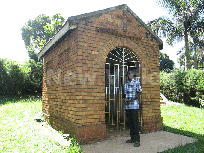   hristian stands at the monument of rapeeras initial burial place at abunnyanear ubaga