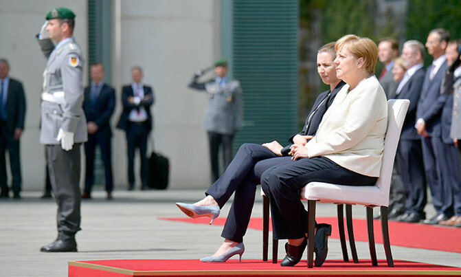 Merkel sits through anthems after shaking spells Merkel sits through anthems after shaking spells