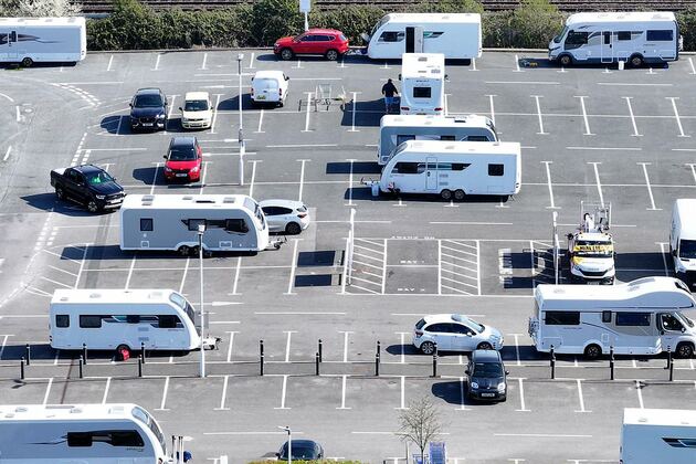 Travellers take over Tesco car park after being removed from local park five minutes down the road