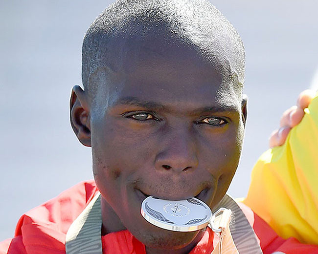 olomon utai poses with one his gold medals