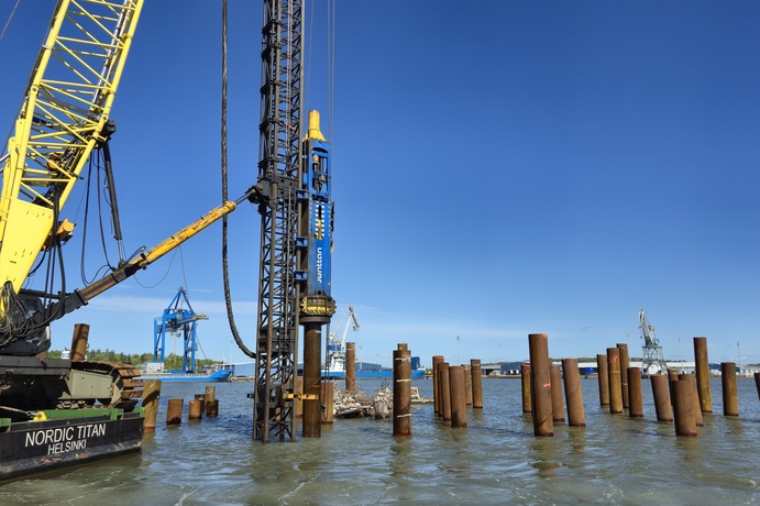 A Junttan’s HHK16S hydraulic impact hammer with Terramare’s crane attached leader installing the piles for the ferry terminal expansion in Turku