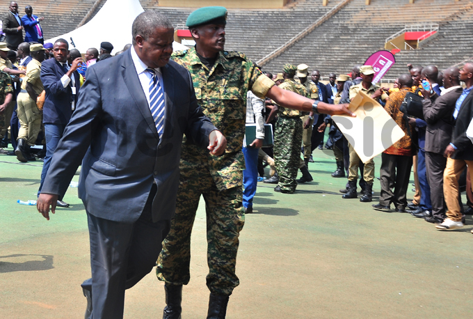 tafiire is led away by security after the incident at amboole tadium hoto by uliet asirye
