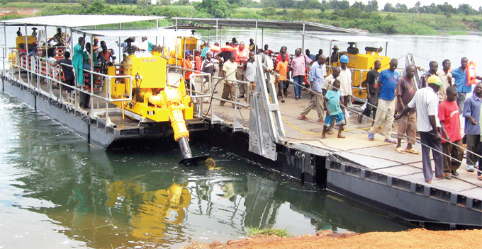 assengers disembark from a ferry that connects balamuti in amuli district to ayunga district