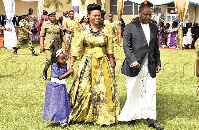 he abagereka of uganda ylvia agginda in an olive green dress gomesi designed with a full line skirt and matching sash