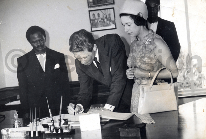 kangi  looks on as ord nowdon and rincess argaret sign a visitors book during a visit in 1964