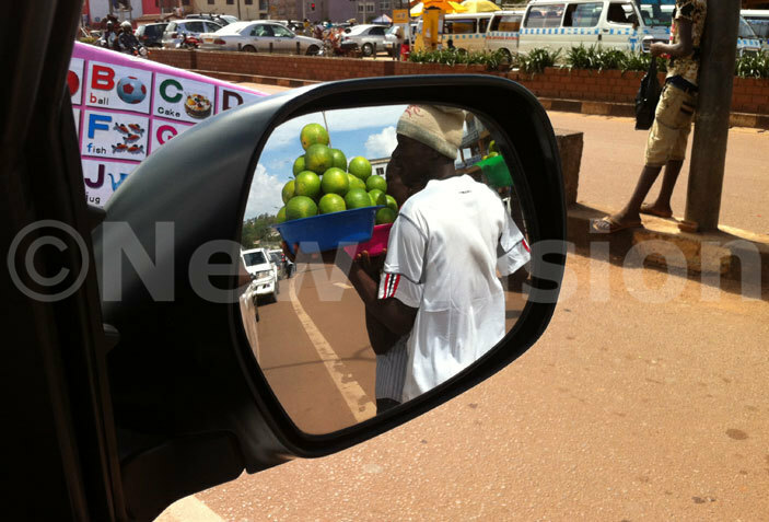   endor selling oranges to motorists stuck in traffic jam at andegeya junction hoto by shraf  asirye