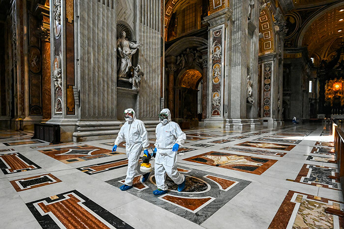  en wearing protective overalls and mask carry sanitizing spray during the sanitation of t eters asilica in he atican on ay 15 2020 during the lockdown aimed at curbing the spread of the 19 infection caused by the novel coronavirus