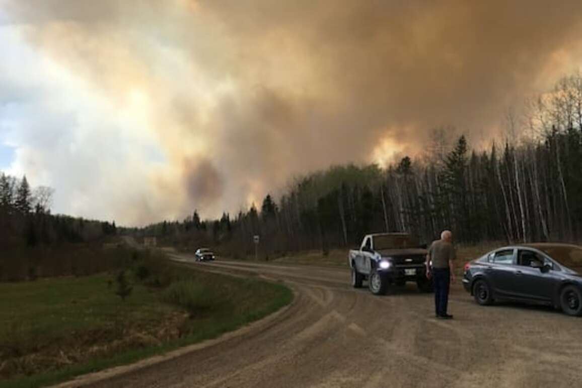 Firefighters battling Nopiming wildfire in 'protection mode' to save buildings, cabins