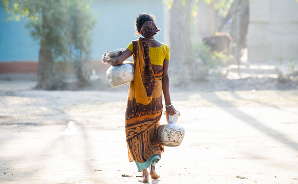  Bengali woman is carrying water jars walking in a small village in Srimangal, Bangladesh | Credit: iStock
