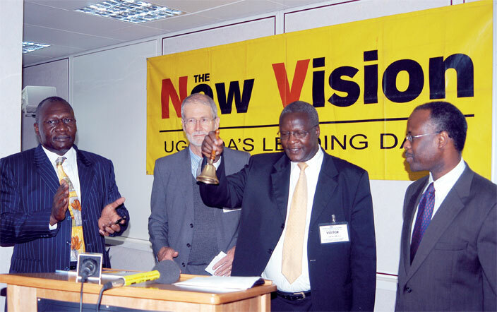 hief ustice art atureebe who was then board chair for ew ision rings the bell at the listing of the ew ision on the securities exchange on ecember 16 2004 ooking on are negi bel left illiam ike and obert utaagi