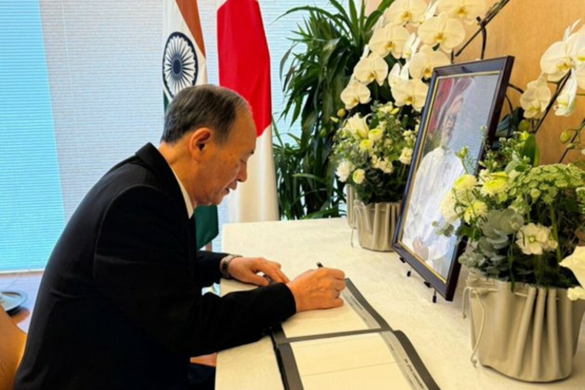 Former Japanese PM Yoshihide Suga signs condolence book in memory of Manmohan Singh at Indian Embassy