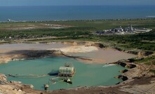 An aerial view of the mine pond, processing plant and jetty at Moma.