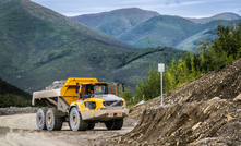 A Volvo 60 short ton (54.4t) articulated hauler begins its climb up the 6.4km-long, 12-14° gradient road to the Pogo dry dump