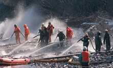 An oil spill cleanup team work against the odds (unrelated)