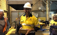  Saracen managing director Raleigh Finlayson with a gold bar at Carosue Dam in Western Australia