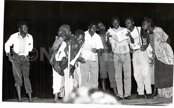 illagers listen to a  official reading to them a copy of the raft onstitution in a scene of the play   staged at the ational heatre by akerere niversity tudents of  department on ednesday 24111993 hoto by  
