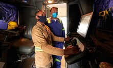  Francis Kaposa (left) trains under the guidance of Rongyun Liu at Kamoa-Kakula's state-of-the-art training centre. As part of the project's extensive training programme, apprentice miners learn to operate automated mining equipment on computerized simulators