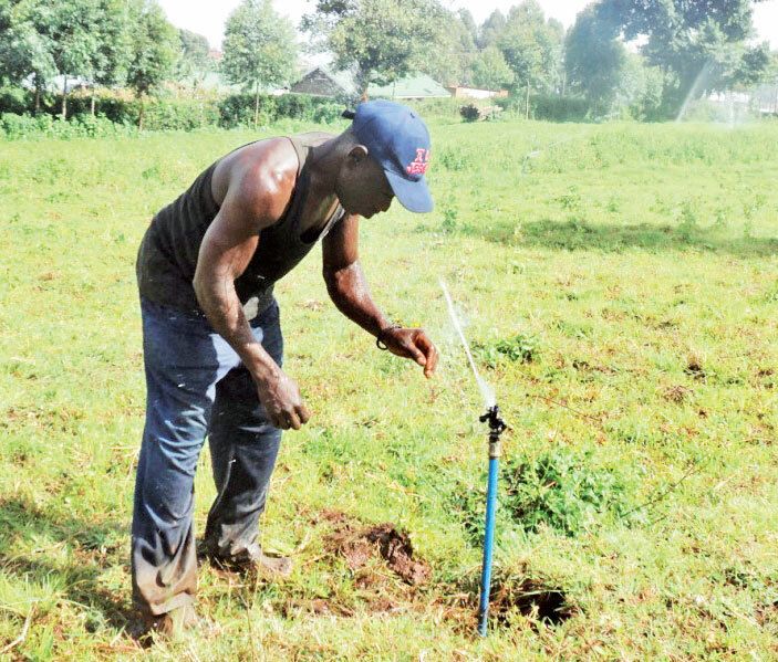   man operating an irrigation system on a farm in apchorwa