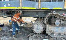  The worker was using a sledgehammer to remove the excavator drive sprocket.