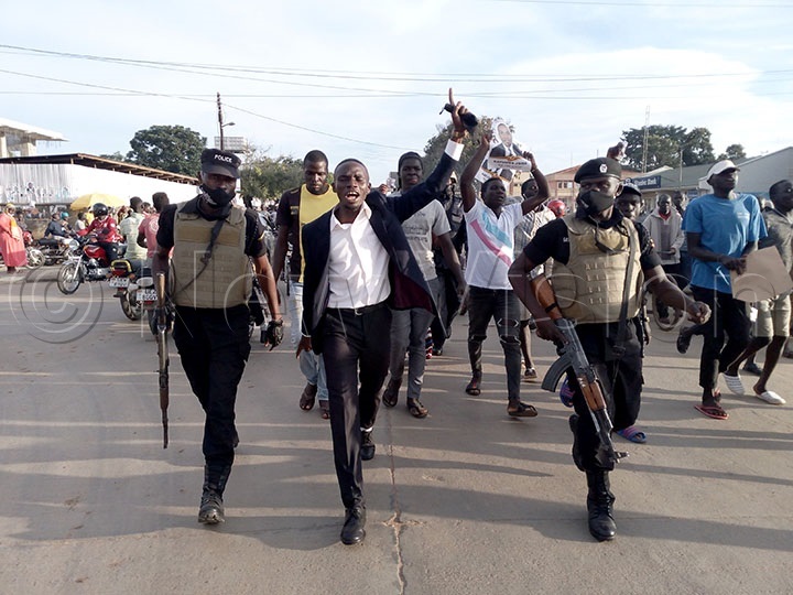John Katumba with his Police escorts and supporters walking on the streets of Arua city 