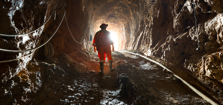 Miner inside the access tunnel of an underground gold and copper mine.