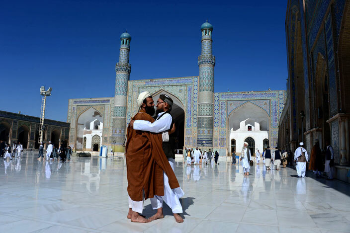  fghan muslims hug after offering prayers at the start of id alitr which marks the end of amadan at the ami mosque in erat province on uly 6 2016  he threeday festival which begins after the sighting of a new crescent moon marks the end of the fasting month of amadan during which devout uslims abstain from food and drink from dawn to dusk      