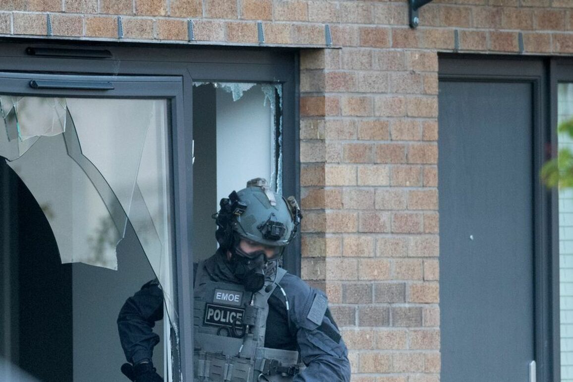 Six men charged after gang war cops storm houses in dawn raids as feud escalates