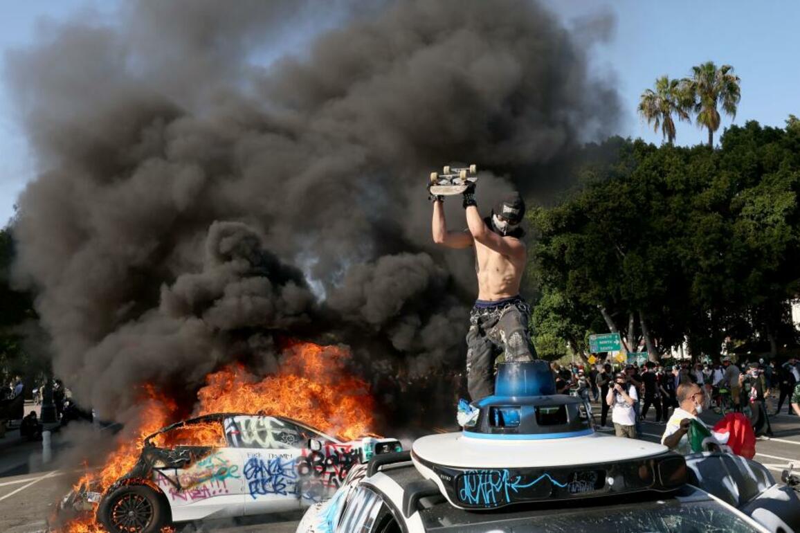 Waymo vehicles set on fire in downtown L.A. as protesters, police clash