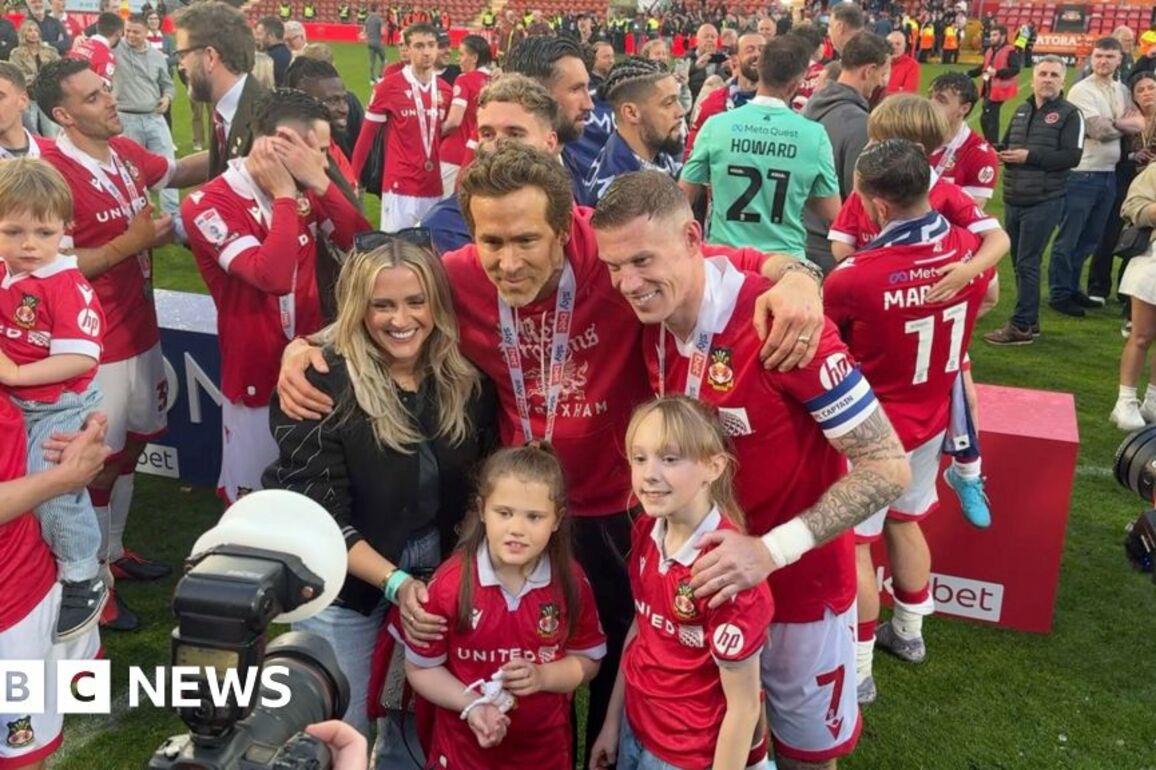 Ryan Reynolds and Wrexham players celebrate after promotion