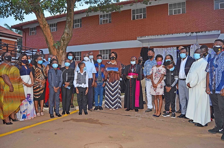 The Kitaka extended family members posing for a group photo with Archbishop Lwanga after the concert
