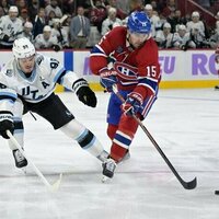 Canadiens F Alex Newhook helped off ice after collision with boards
