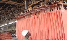 A worker handles copper plates at a Gecamines operation. Photo: Gecamines