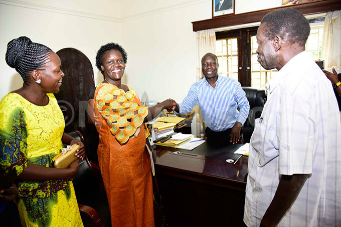  he ational esistance ovement  arty hairperson lectoral ommission anga doi congratulates akwach oman ember of arliament aspirant hristine cayo left as li adriff looks on during nomination for party primaries at  headquarters in akasero on ugust 8 2017 hoto by ennedy ryema