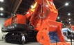 An attendee marvels at the Hitachi EX5600-6 hydraulic excavator