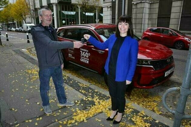 Mallon "hands over" keys to new community electric car for Rathlin Island