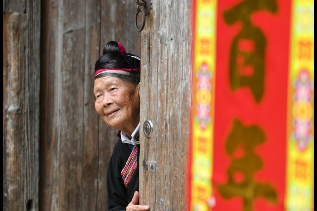 Elderly woman makes efforts to promote local tourism in SE China