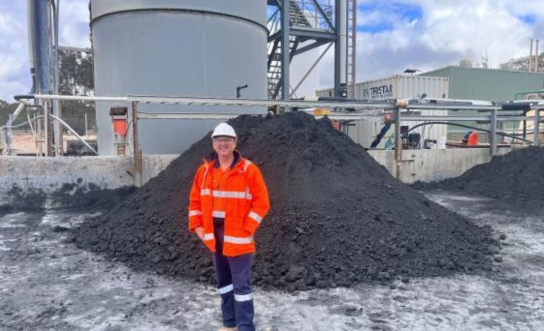 Kingston MD Andrew Corbett in front of concentrate stockpiles.