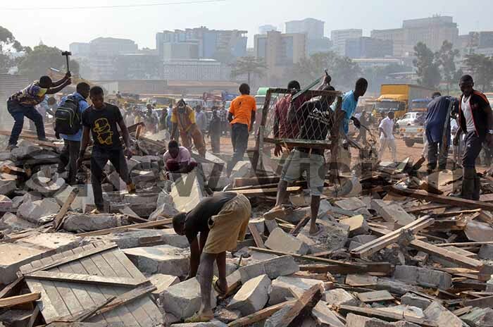  crap collectors looking for metals from debris of houses demolished by  at ganda ailway houses paving way for the construction of the first flyover in ampala by  on uly 26 2019 hoto by adru atumba