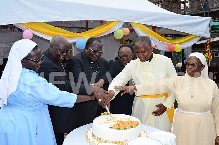  rchbishops ohn aptist dama 2nd  mmanuel bbo  3rd  and yprian izito wanga 4th  cut cake with the representatives of the atholic eligious to launch the year of the golden jubilee of the ssociation of the eligious in ganda 