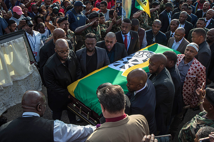  all bearers carry the casket of innie adikizelaandela covered with an  flag as remains of the the antiapartheid icon are returned to her home in oweto ohannesburg on pril 13 2018 