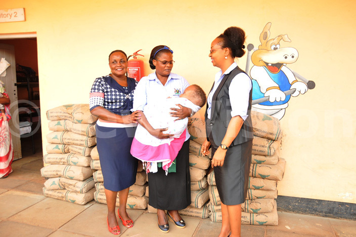  he workers led by the ministrys personnel director atherine usingwire hand over the cement to atalemwa heshire home executive director amalie atovuin blue