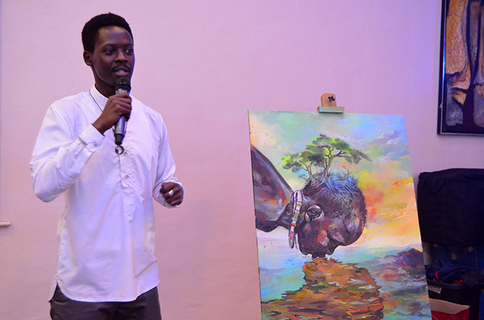 isual artist lex wizera gives an explanation of his art piece which was auctioned at sh10m
