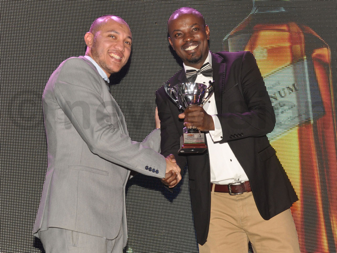 ac ast frica ountry eneral anager haled arid  presents a trophy to nthony gaba one of the winners from the subsdiary event hoto by ichael subuga