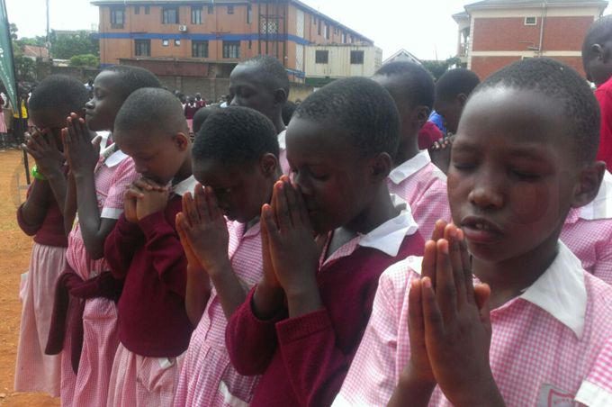  he pupils say a prayer at the start of the planting exercise hoto by iriam amutebi