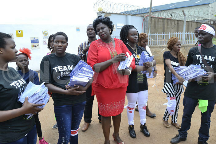  aby loria with her mother etty akibuka and other artists giving out scholastic materials to children in hetto amuwongo